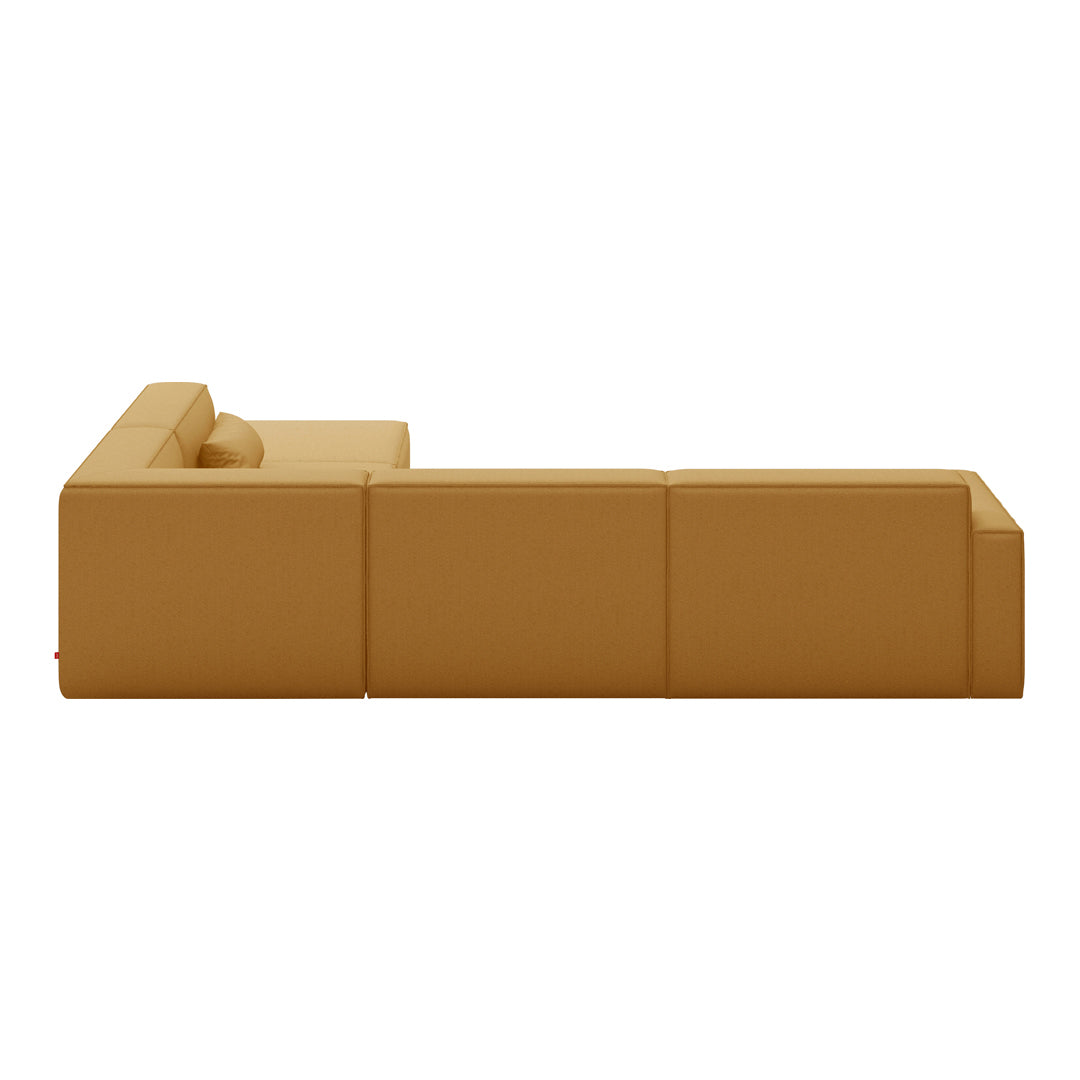 "Modern sectional sofa in rich mustard yellow with a sleek, minimalist design and smooth fabric upholstery."