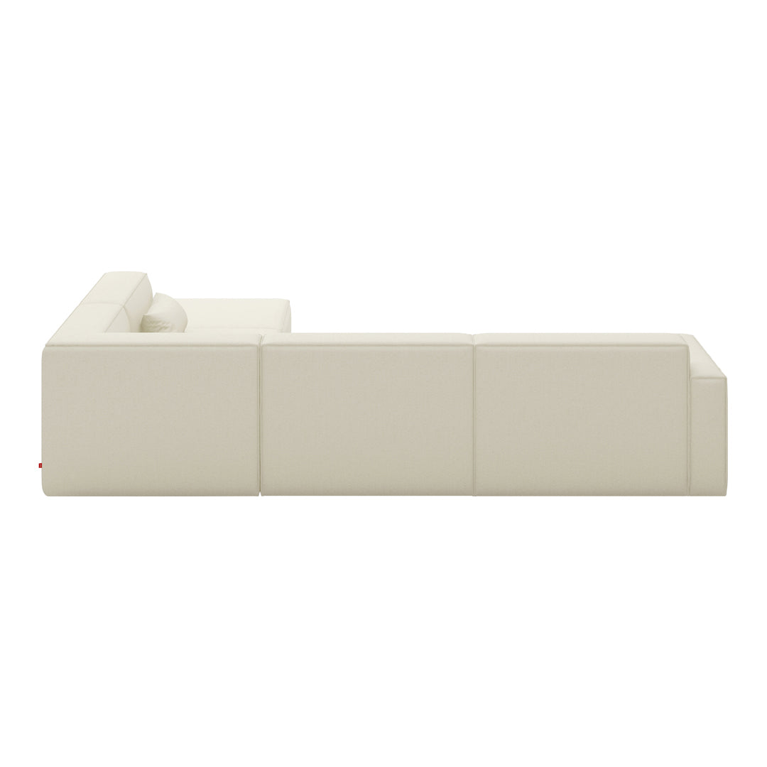 Beige sectional sofa with smooth, modern lines and a minimalist design. Perfect for contemporary living spaces.