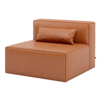 Tan upholstered lounge chair with a smooth texture and a matching decorative pillow. Modern, minimalist design.