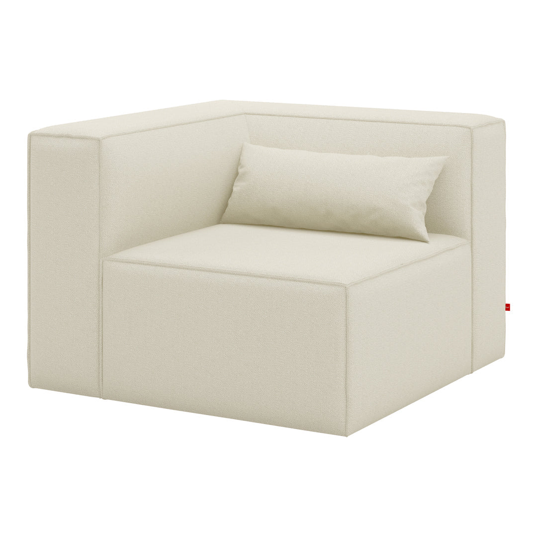 Cream-colored modern corner sofa with a minimalist design and smooth fabric texture, featuring a matching cushion.