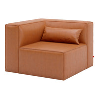 "Modern corner sofa in warm tan fabric with subtle texture and a matching lumbar pillow."