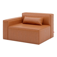 Brown leather armchair with a smooth texture and simple, modern design, accented by a matching pillow.
