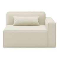 Cream-colored modern chaise lounge with a smooth texture and simple, minimalist design. Includes a matching pillow.