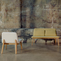 Modern two-tone sofa in soft yellow and white, featuring a minimalist design with natural wood legs.