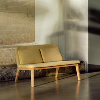 Sleek yellow sofa with clean lines and wooden legs, perfect for modern decor.