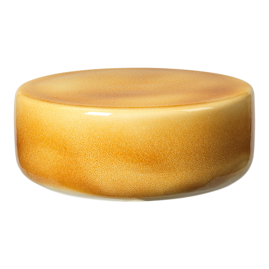 Glossy round table in warm amber and golden gradient, featuring smooth, subtle patterns and a sleek finish.