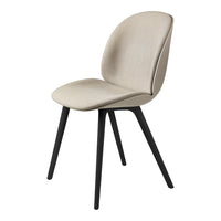 Beige fabric dining chair with sleek black legs, featuring a smooth, minimalist design. Perfect for modern decor.