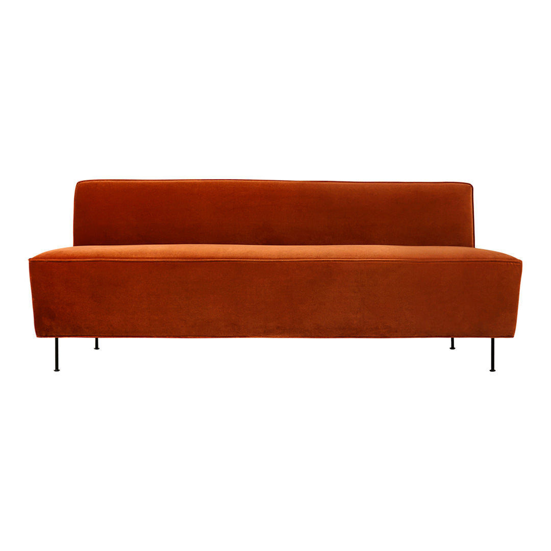 Mid-century modern sofa in rich burnt orange with a smooth, solid texture and sleek black legs.