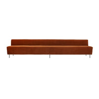 Modern long sofa in rich terracotta color with a sleek, minimalistic design and smooth upholstery.