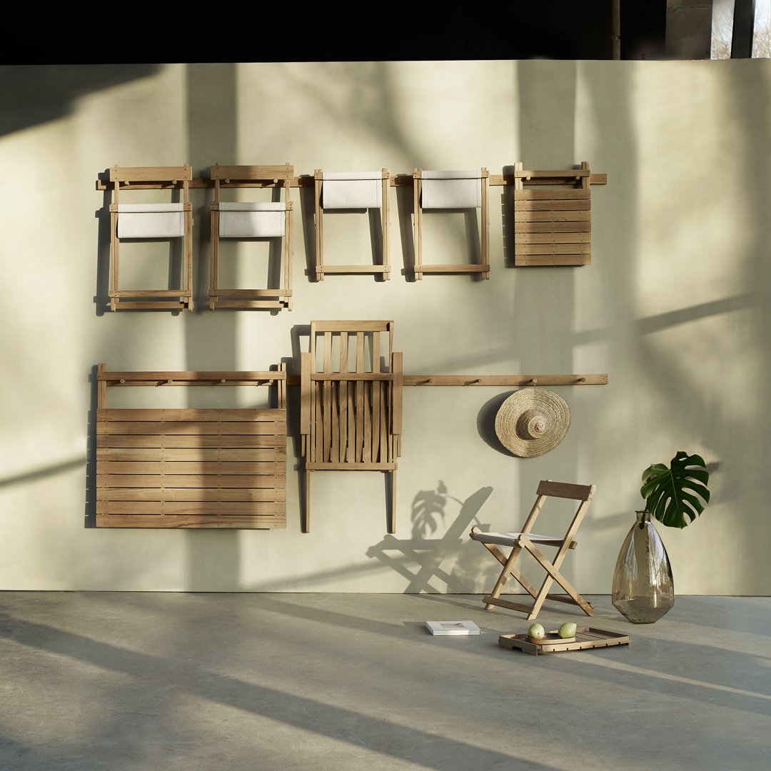 Wooden furniture in natural tones mounted on a soft green wall, featuring white accents and shadows for a serene aesthetic.