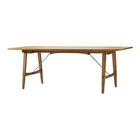 Natural wood dining table with a warm honey finish and a sleek, minimalist design, featuring solid legs and subtle metal accents.
