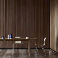 "Wooden wall paneling in rich brown tones with modern blue and white vases on a minimalist table. Contemporary design."