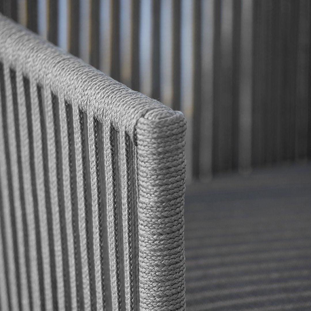 Gray striped outdoor chair with a sleek, modern design and textured rope detailing. Ideal for contemporary spaces.