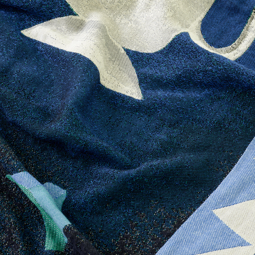 Textured fabric with navy, light blue, and white abstract patterns creating a modern, artistic look.