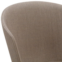 Light brown textured upholstery with a subtle woven pattern on a stylish chair.
