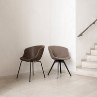 Brown upholstered chairs with sleek black metal legs, featuring a modern and minimalist design.