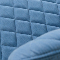 Close-up of quilted blue fabric featuring a textured diamond pattern. Ideal for modern home decor.