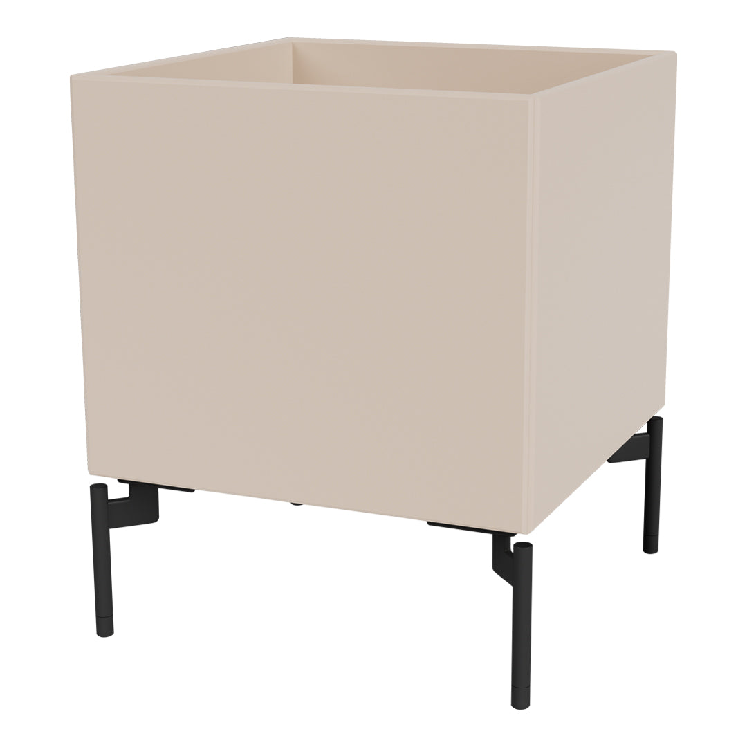 Neutral beige planter with a sleek, modern design and contrasting black metal legs. Ideal for contemporary decor.