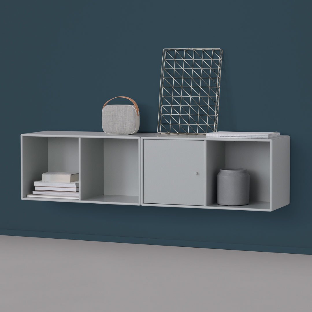 Stylish gray wall-mounted shelf with smooth surfaces against a deep blue backdrop. Modern, minimalist design.