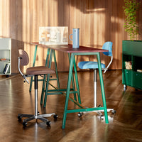 Colorful modern bar stools with blue, brown, and green accents, featuring sleek designs and contrasting patterns.