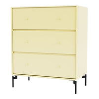 Yellow dresser with three smooth drawers and subtle rounded knobs, accented by sleek black legs.