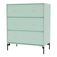 Mint green dresser with sleek black legs and minimalist design, featuring three spacious drawers.