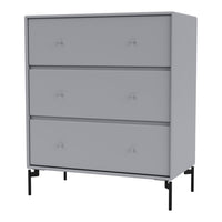 Gray three-drawer dresser with smooth surfaces and subtle button details, featuring black metal legs.