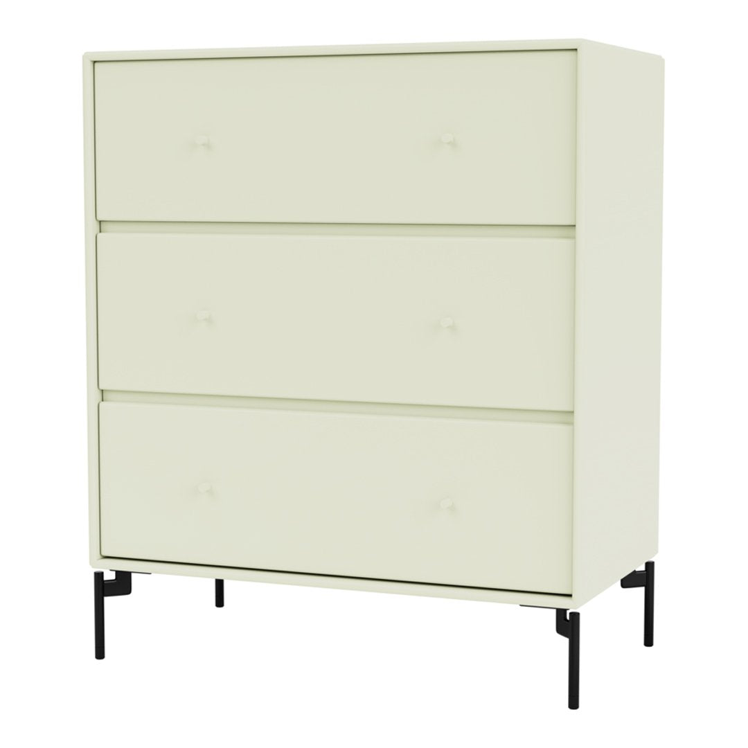 Light green, minimalist dresser with three drawers, topped with black legs for a modern contrast.