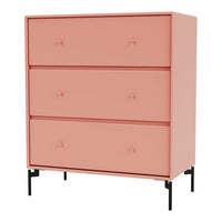 Blush pink dresser with three drawers and stylish black legs, featuring a smooth, minimalistic design.