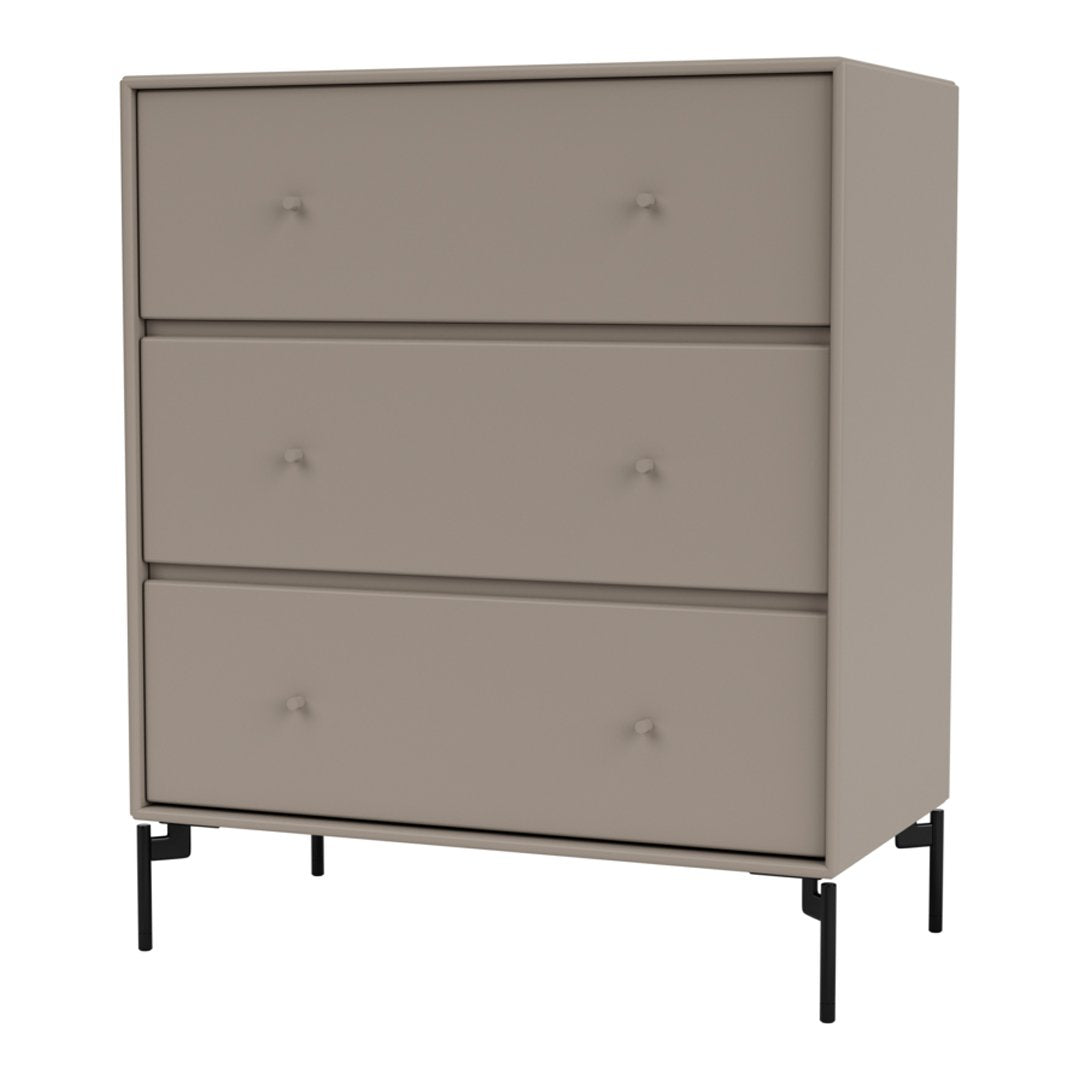 Beige three-drawer dresser with matte finish and black metal legs, featuring simple knob handles. Modern and minimalist design.
