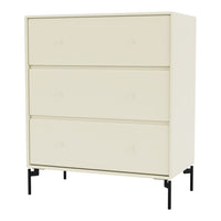 Light cream dresser with minimalist design and three smooth drawers on sleek black legs.