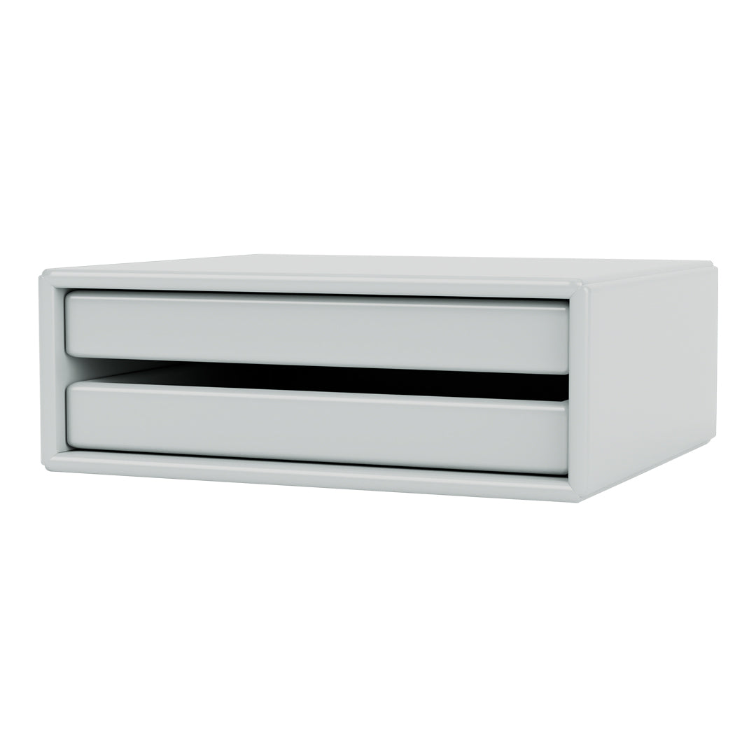 Minimalist white storage drawer with smooth, sleek surfaces and contrasting black drawer openings.