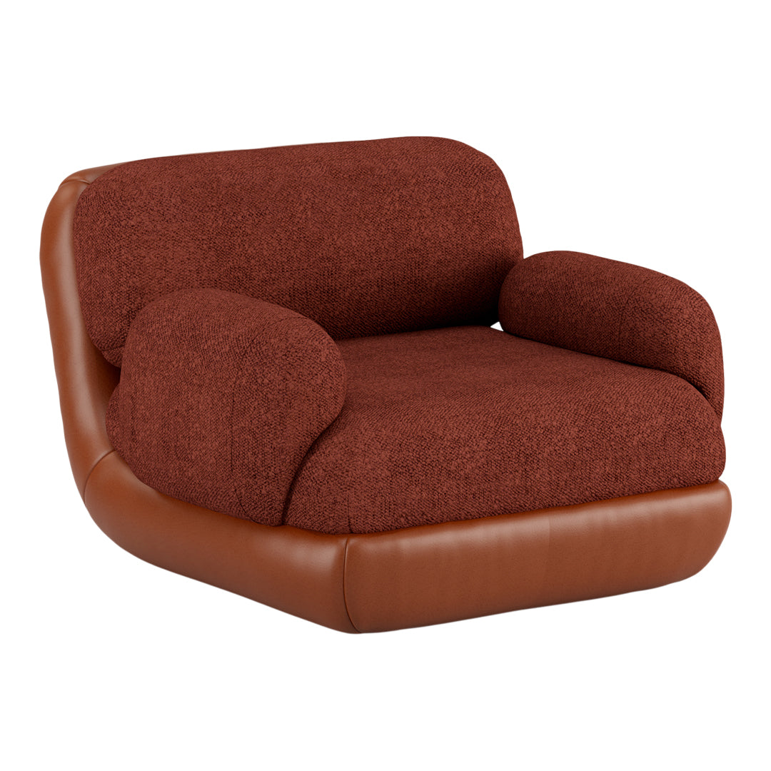 Rust-colored textured fabric chair with smooth brown leather base and rounded arms, perfect for modern decor.