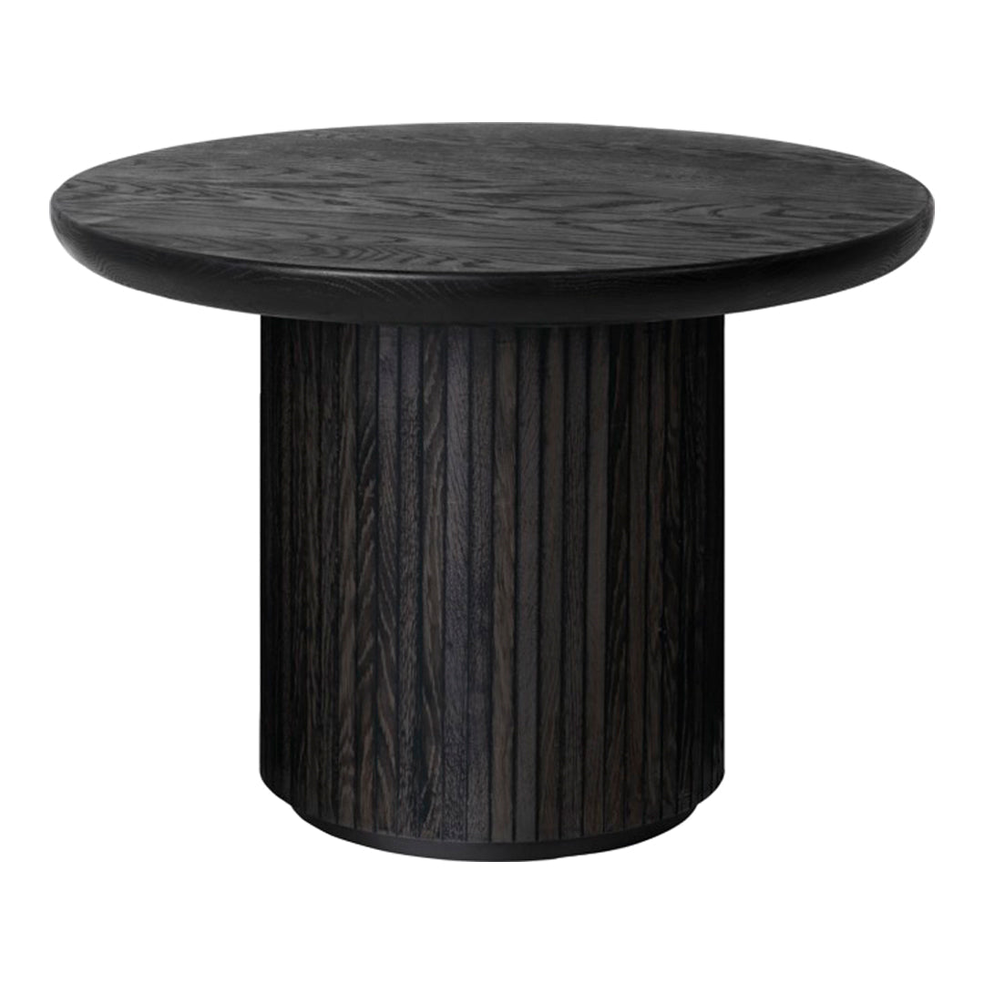 Round black wood table with textured, patterned surface and vertical striped pedestal base.