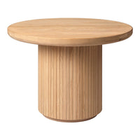Round wooden table with a natural light wood finish and vertical ribbed pattern on the pedestal base.