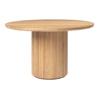 Round wooden dining table with a natural finish and vertical stripe pattern on the pedestal base.
