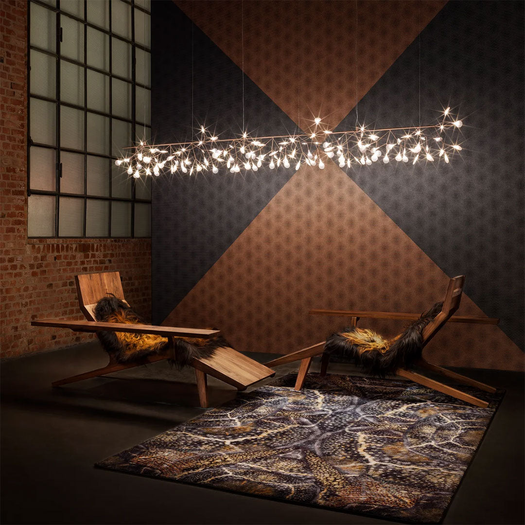 "Modern living room with geometric patterns in earthy tones, featuring a textured rug and warm wooden furniture."