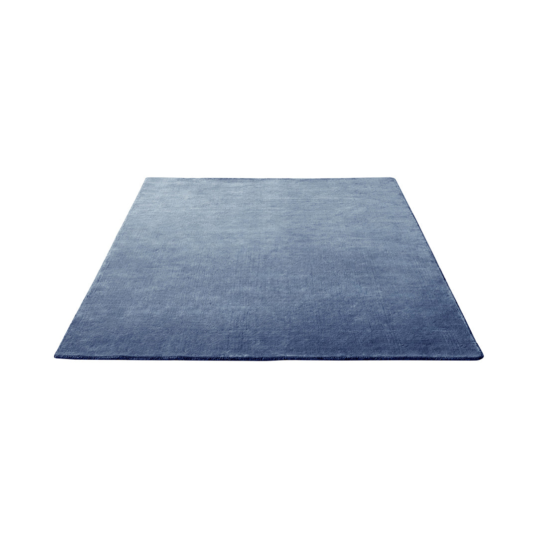 Solid navy blue rug with a smooth, textured surface, perfect for modern and minimalist decor.