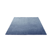 Solid navy blue rug with a smooth, textured surface, perfect for modern and minimalist decor.
