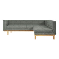 Gray tufted sectional sofa with natural wood legs, featuring a modern, minimalist design. Perfect for contemporary spaces.