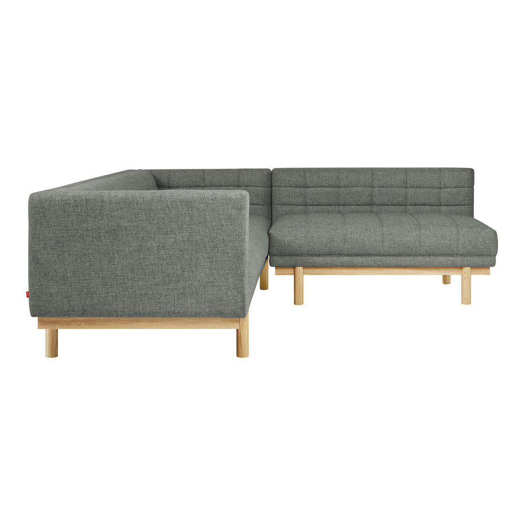 Gray upholstered sectional sofa with a grid pattern and light wood legs. Modern design for stylish living spaces.