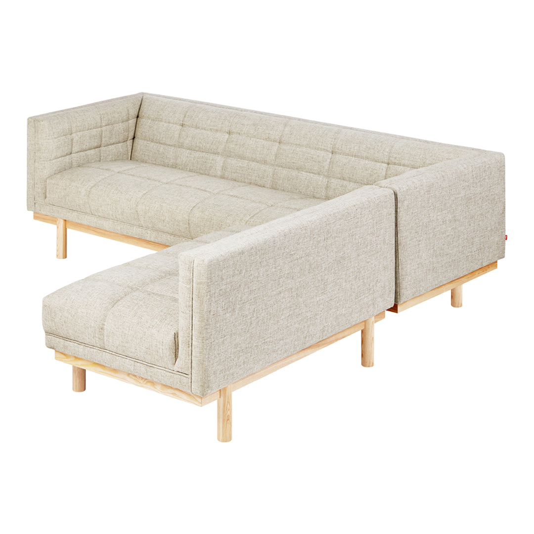 Light beige linen corner sofa with tufted pattern and natural wood legs, offering a modern and cozy aesthetic.