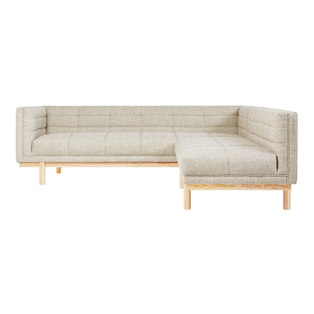 Light beige sectional sofa with a quilted pattern and natural wood legs. Perfect for modern living spaces.