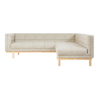 Light beige sectional sofa with a quilted pattern and natural wood legs. Perfect for modern living spaces.