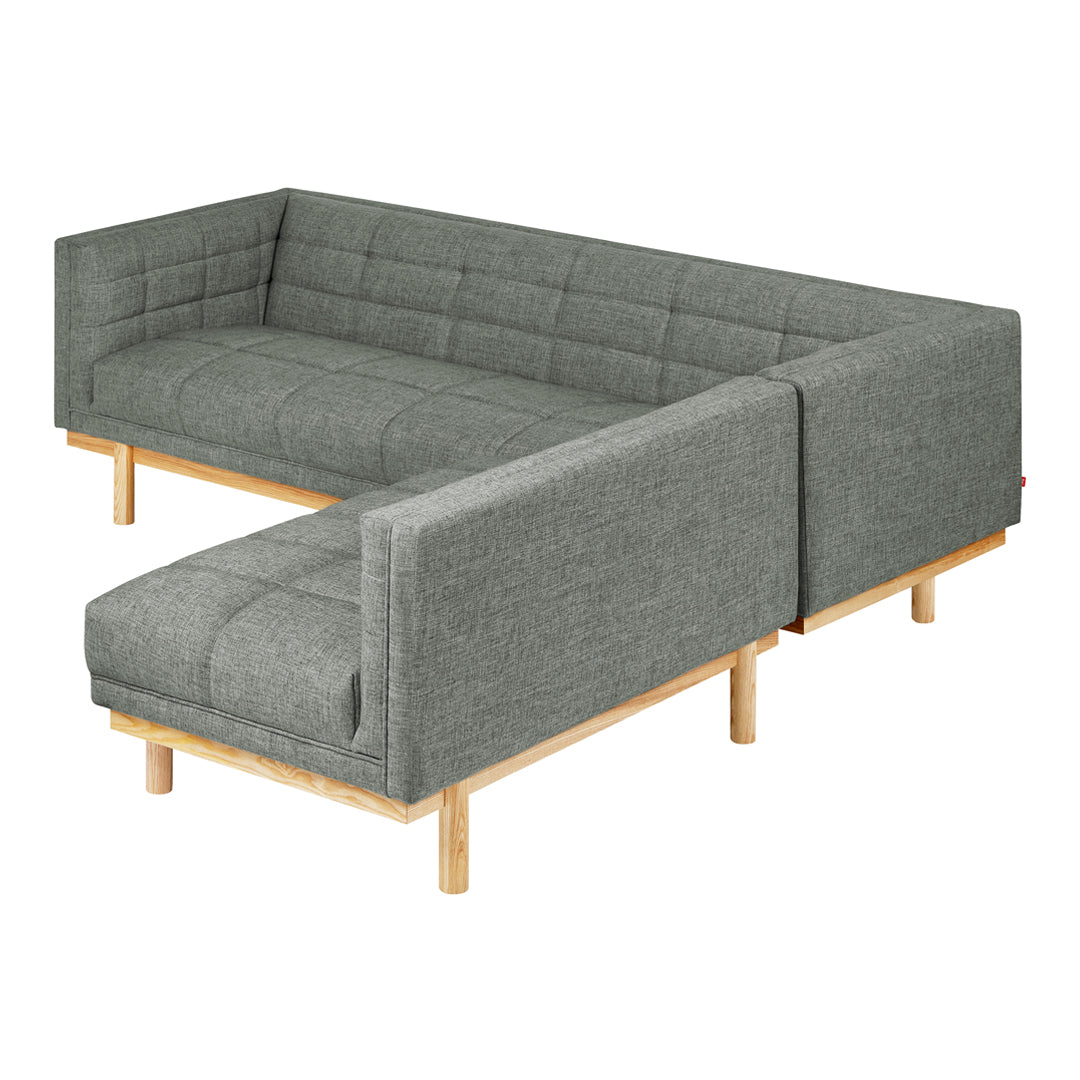 Gray upholstered sectional sofa with a modern tufted pattern and light wood legs, perfect for contemporary living spaces.