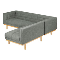 Gray upholstered sectional sofa with a modern tufted pattern and light wood legs, perfect for contemporary living spaces.