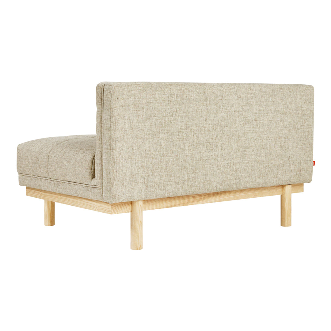 Light beige textured fabric sofa with a clean, minimalist wooden base, showcasing a simple, modern design.