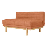 Rust-colored tufted lounge sofa with a minimalist design and light wooden legs. Ideal for modern interiors.