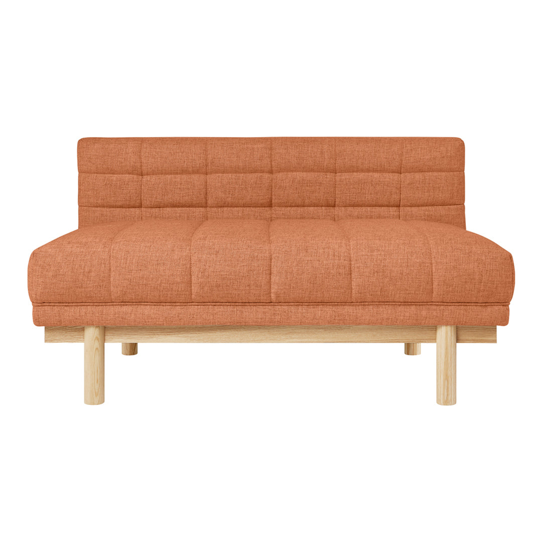Orange tufted sofa with natural wood legs, featuring a minimalist design and contemporary style.