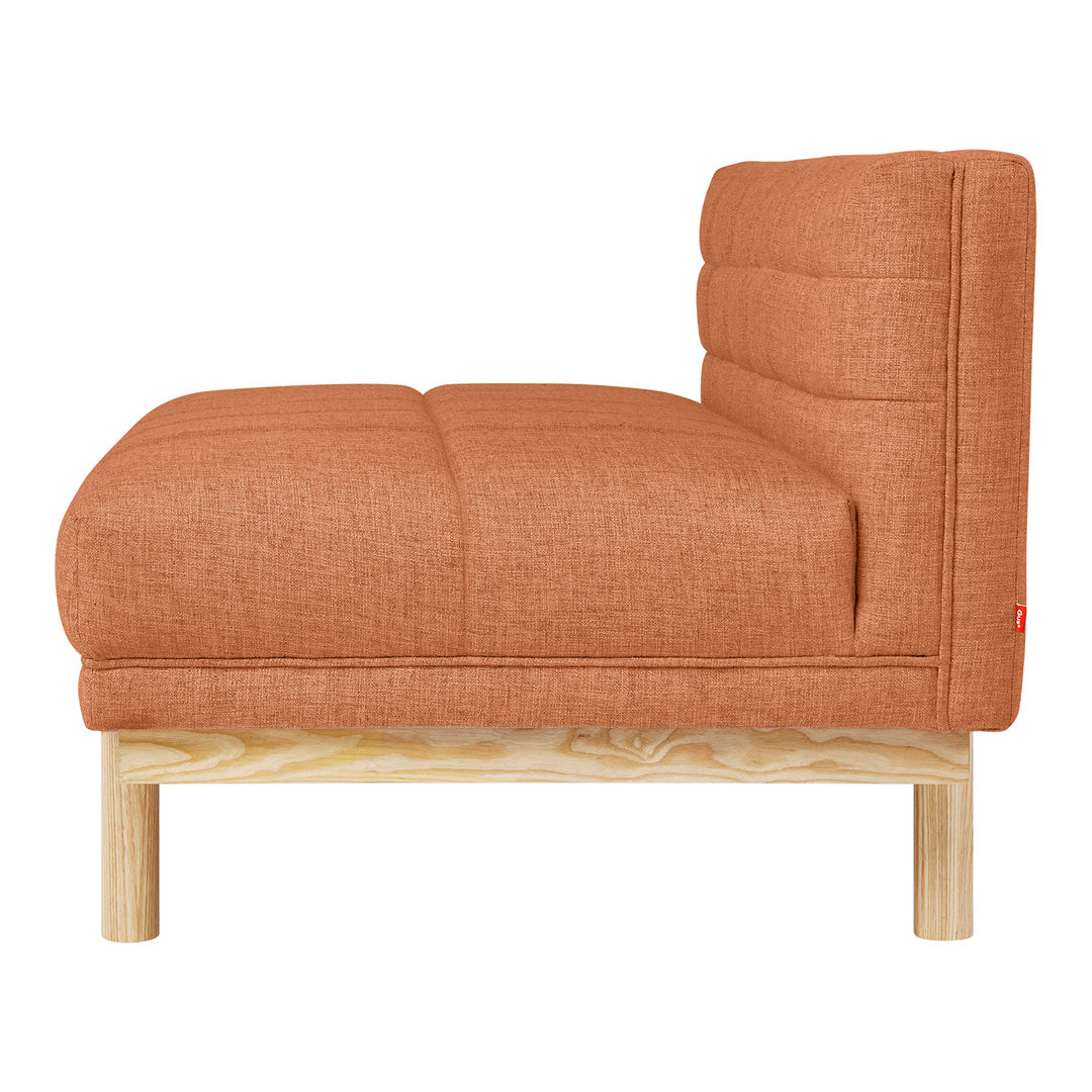 Rust-colored upholstered chair with a tufted pattern and natural wood frame, perfect for modern decor.